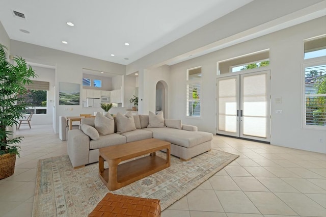 living room with french doors and light tile patterned floors