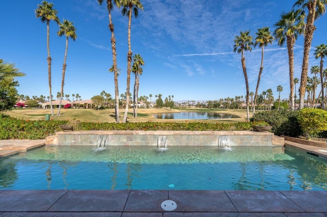 view of pool with a water view and a yard