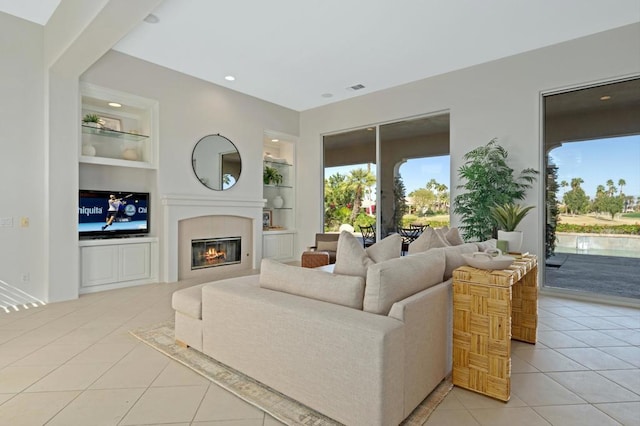 tiled living room featuring built in shelves