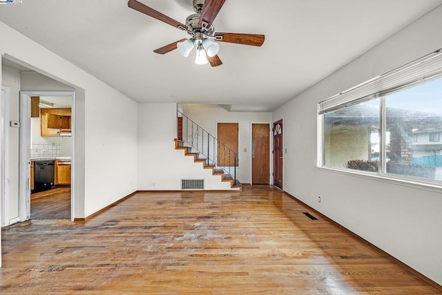 unfurnished living room featuring light hardwood / wood-style floors and ceiling fan