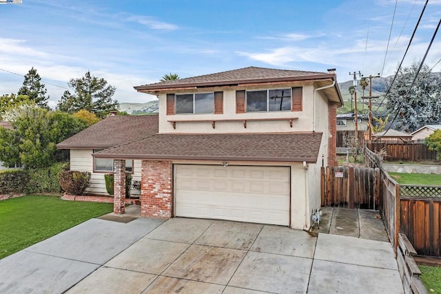 view of front property featuring a garage and a front yard