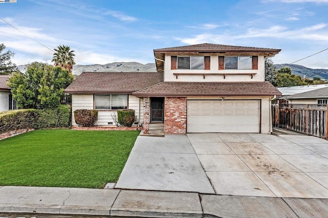 view of front facade with a mountain view, a garage, and a front lawn