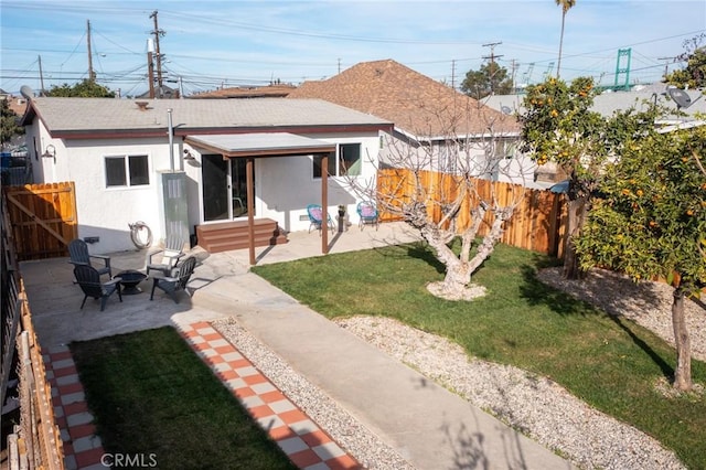 rear view of property featuring a patio area and a lawn