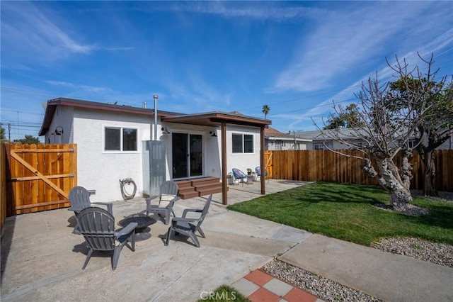 back of house with a yard and a patio area