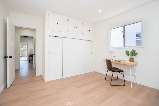 interior space with light wood-type flooring and a closet