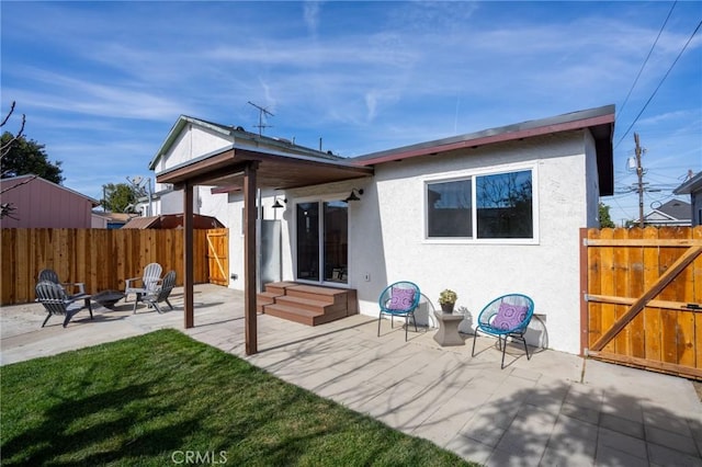 rear view of property with a patio area and a lawn