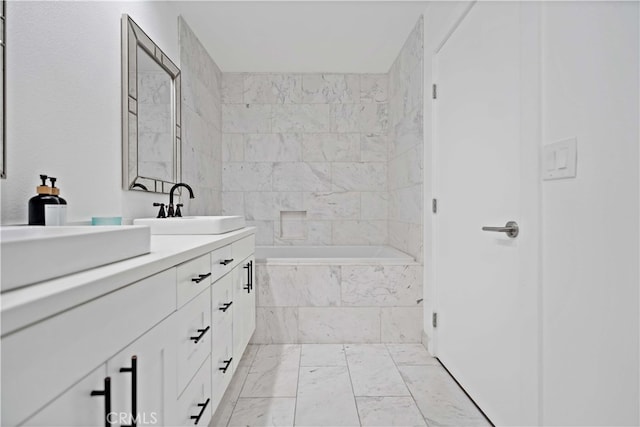 bathroom featuring vanity and tiled bath