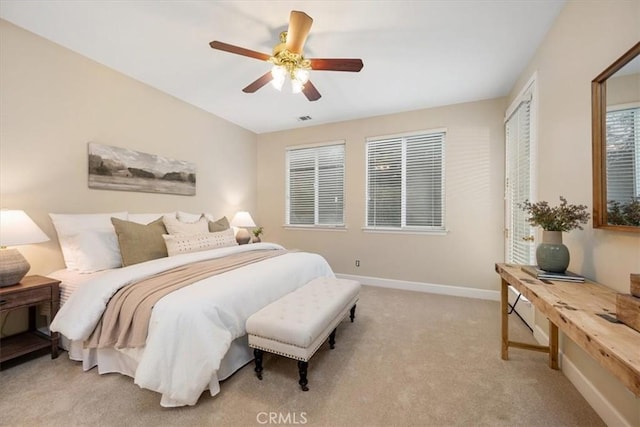 bedroom featuring light carpet and ceiling fan