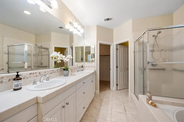 bathroom with tile patterned floors, separate shower and tub, and vanity