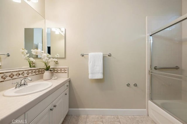 bathroom with tasteful backsplash, enclosed tub / shower combo, tile patterned floors, and vanity