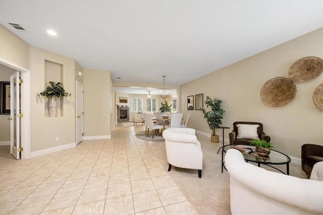 tiled living room featuring a notable chandelier