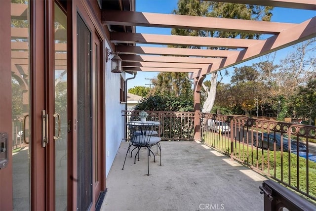 view of patio / terrace with a pergola, french doors, and a balcony