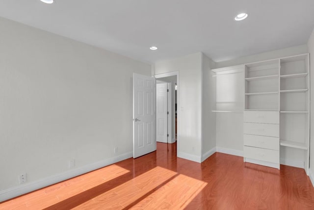 unfurnished bedroom featuring hardwood / wood-style flooring and a closet