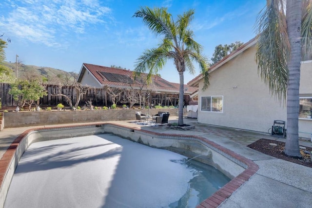 view of pool featuring a mountain view and a patio