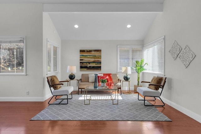 living area with vaulted ceiling with beams and dark hardwood / wood-style floors