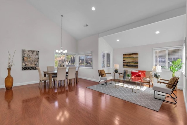 interior space featuring an inviting chandelier, hardwood / wood-style floors, plenty of natural light, and high vaulted ceiling