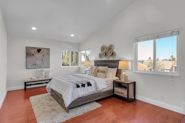 bedroom with lofted ceiling and wood-type flooring