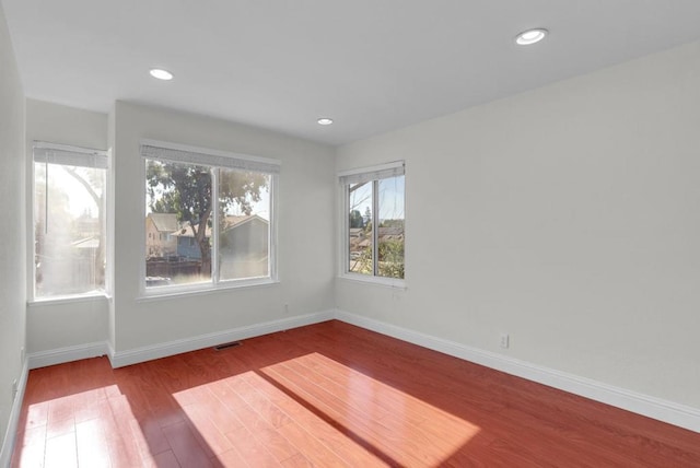 unfurnished room with light wood-type flooring