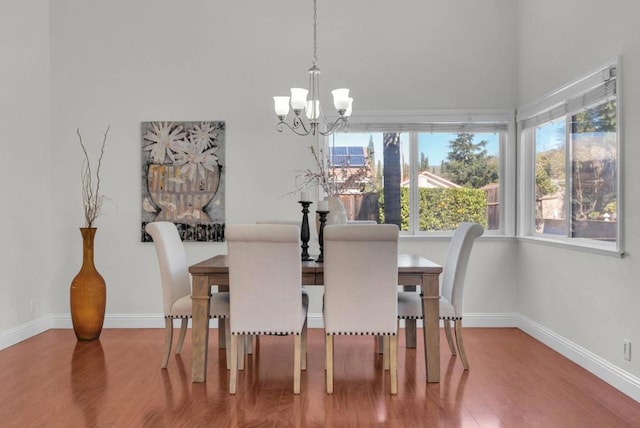 dining area featuring an inviting chandelier and hardwood / wood-style floors