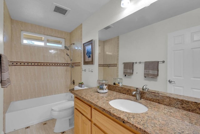 full bathroom featuring vanity, toilet, and tiled shower / bath combo