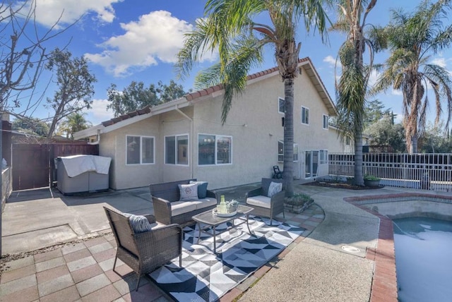 rear view of property with outdoor lounge area, a fenced in pool, and a patio area