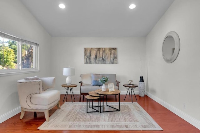 sitting room with lofted ceiling and hardwood / wood-style floors