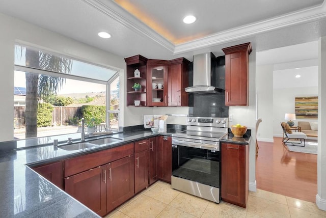 kitchen featuring sink, stainless steel range with electric cooktop, ornamental molding, a raised ceiling, and wall chimney exhaust hood