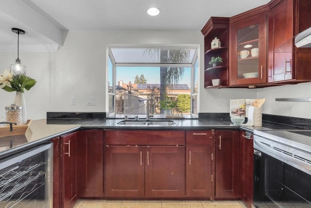 kitchen featuring wine cooler, sink, pendant lighting, and stainless steel electric range oven