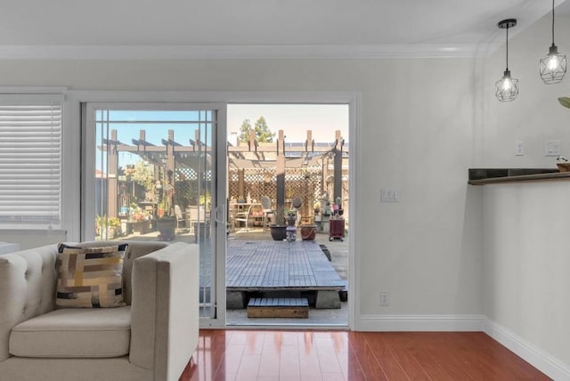 doorway with hardwood / wood-style flooring and ornamental molding