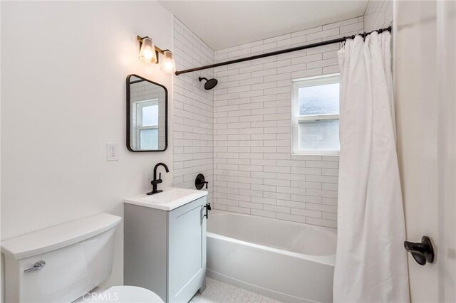 full bathroom featuring vanity, toilet, and shower / bath combo with shower curtain