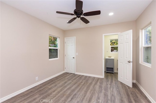 unfurnished bedroom with recessed lighting, ceiling fan, baseboards, and wood finished floors