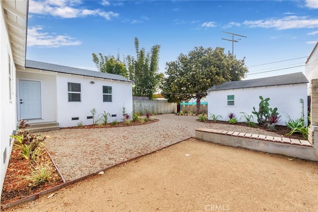 view of yard featuring a patio area, fence, and an outdoor structure