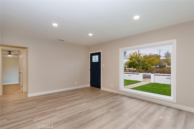 entrance foyer featuring light wood-type flooring, baseboards, and recessed lighting