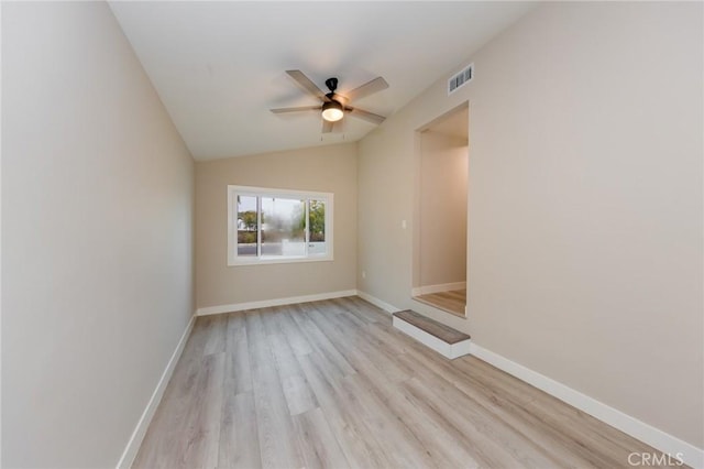 unfurnished room featuring ceiling fan, baseboards, visible vents, and light wood-style floors