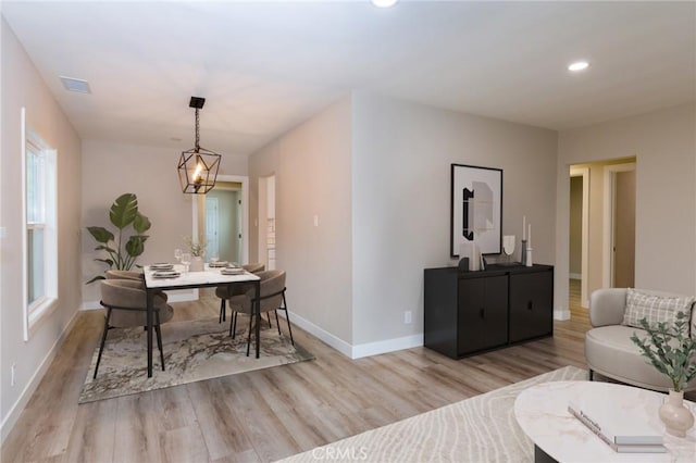 dining area with recessed lighting, wood finished floors, an inviting chandelier, and baseboards