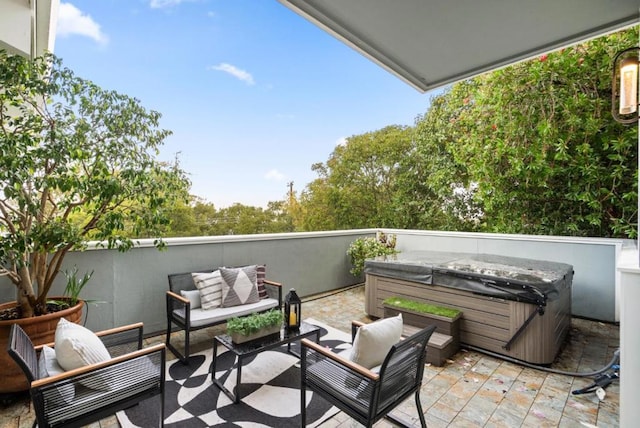 balcony featuring outdoor lounge area and a hot tub