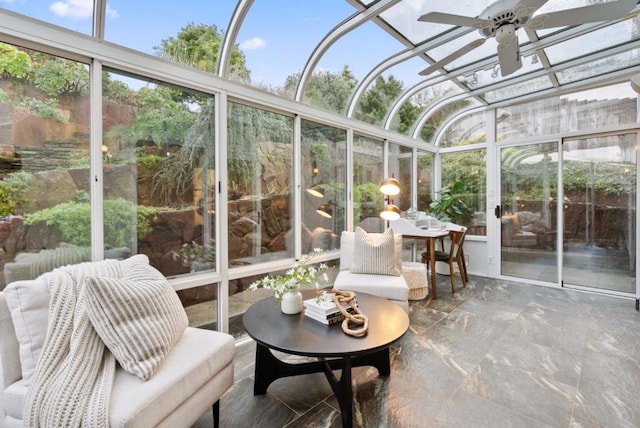 sunroom featuring ceiling fan