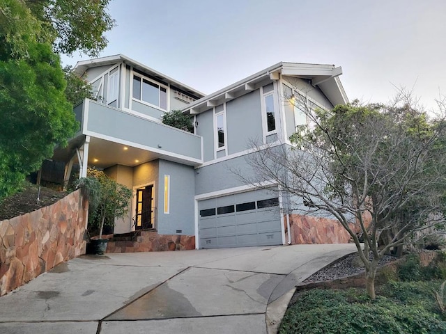 view of front of home with a balcony and a garage