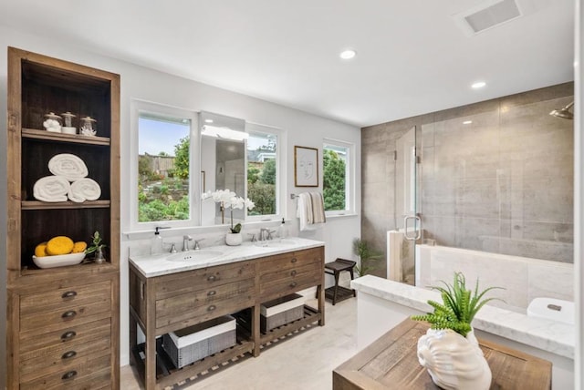 bathroom featuring vanity and an enclosed shower