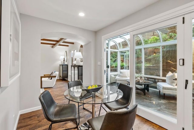 dining area with beamed ceiling, wood-type flooring, and coffered ceiling