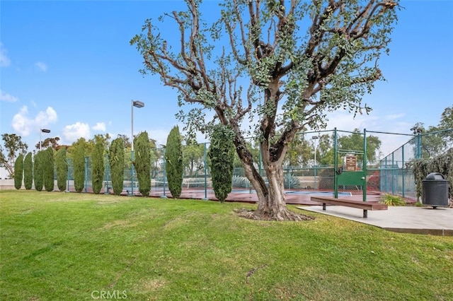 surrounding community featuring a lawn and tennis court