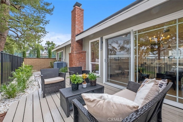 wooden terrace featuring outdoor lounge area