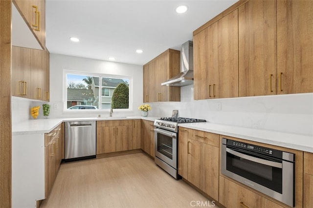 kitchen featuring wall chimney exhaust hood, sink, stainless steel appliances, light hardwood / wood-style floors, and backsplash