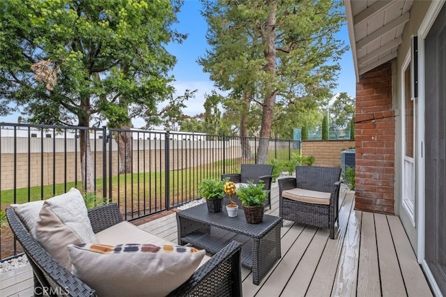 wooden deck with an outdoor hangout area and a lawn