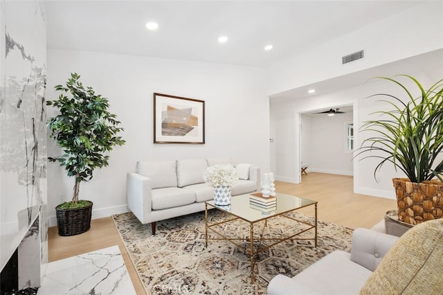 living room with ceiling fan and light wood-type flooring