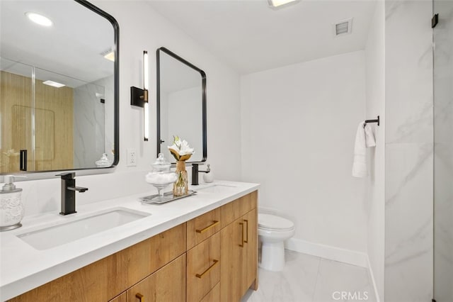 bathroom with vanity, toilet, and a shower with door