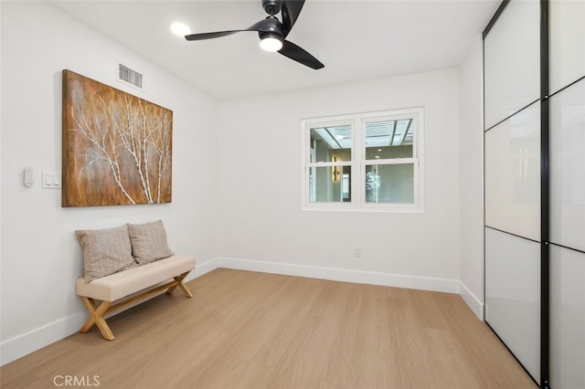 sitting room featuring light hardwood / wood-style flooring and ceiling fan