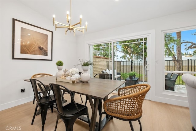 dining space with a chandelier and light wood-type flooring