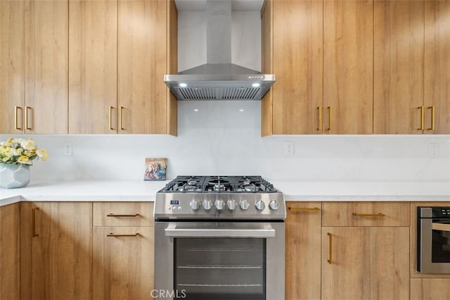 kitchen featuring stainless steel appliances and wall chimney exhaust hood