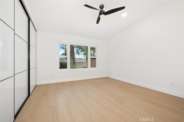 unfurnished bedroom featuring vaulted ceiling, ceiling fan, and light hardwood / wood-style floors